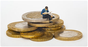 person sitting on coins